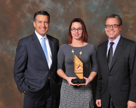   Nevada Governor Brian Sandoval (Left), Kylee Bozarth (Center), and Peter Gunnerman (Right) accepting a company award in December 2014.
